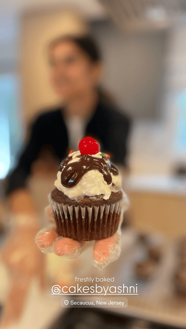 baker holding cupcake sunday - custom eggless hero cake by Cakes by Ashni